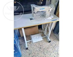 BRAND NEW SEWING MACHINE WITH TABLE AND ALL ACCESSORIES. 